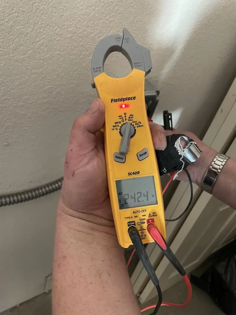 Voltage testing with clamp meter during Ceiling Fan Installation in Hudson Falls
